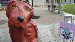 sculpture of a dog in slack plaza.